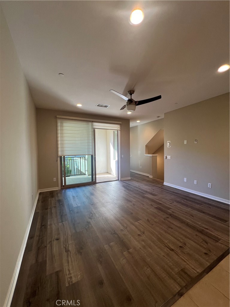 177 Magnet Irvine, CA 92618 - Photo 25 of 37 a view of an empty room with wooden floor and a window