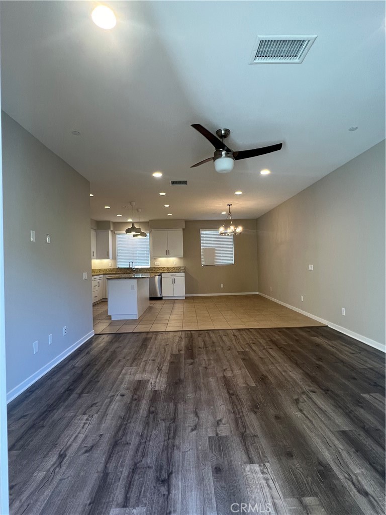 177 Magnet Irvine, CA 92618 - Photo 8 of 37 a view of an empty room with wooden floor and a ceiling fan