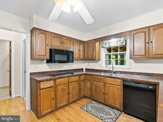 a kitchen with a sink cabinets and window