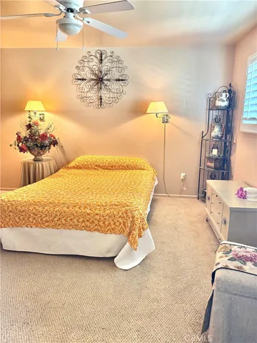 a bedroom with a bed and ceiling fan