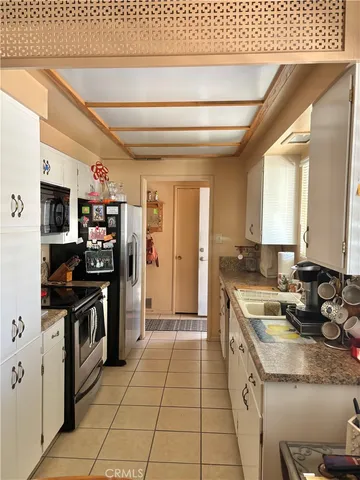 a large kitchen with stainless steel appliances granite countertop a sink and cabinets