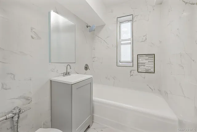 a white bath tub sitting next to a white sink