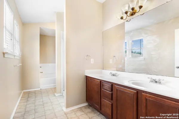 a bathroom with a sink a mirror and a shower