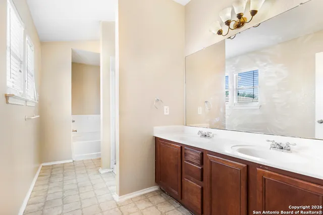 a bathroom with a sink a mirror and a shower
