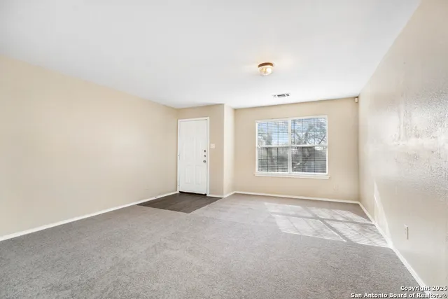 a view of an empty room with a window