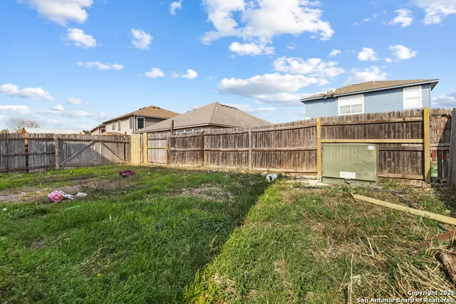a view of a house with a big yard and large trees