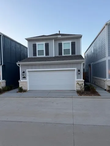 a view of a house with more windows and a small yard