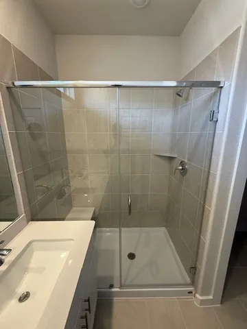 a bathroom with a shower and a sink