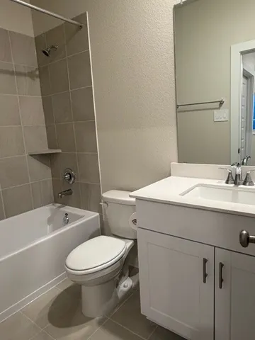 a bathroom with a toilet a sink and bathtub