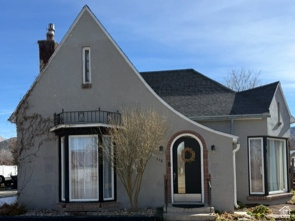 448 North 100 East Nephi, UT 84648 - Photo 1 of 1 View of front facade featuring a chimney, a front lawn, and stucco siding