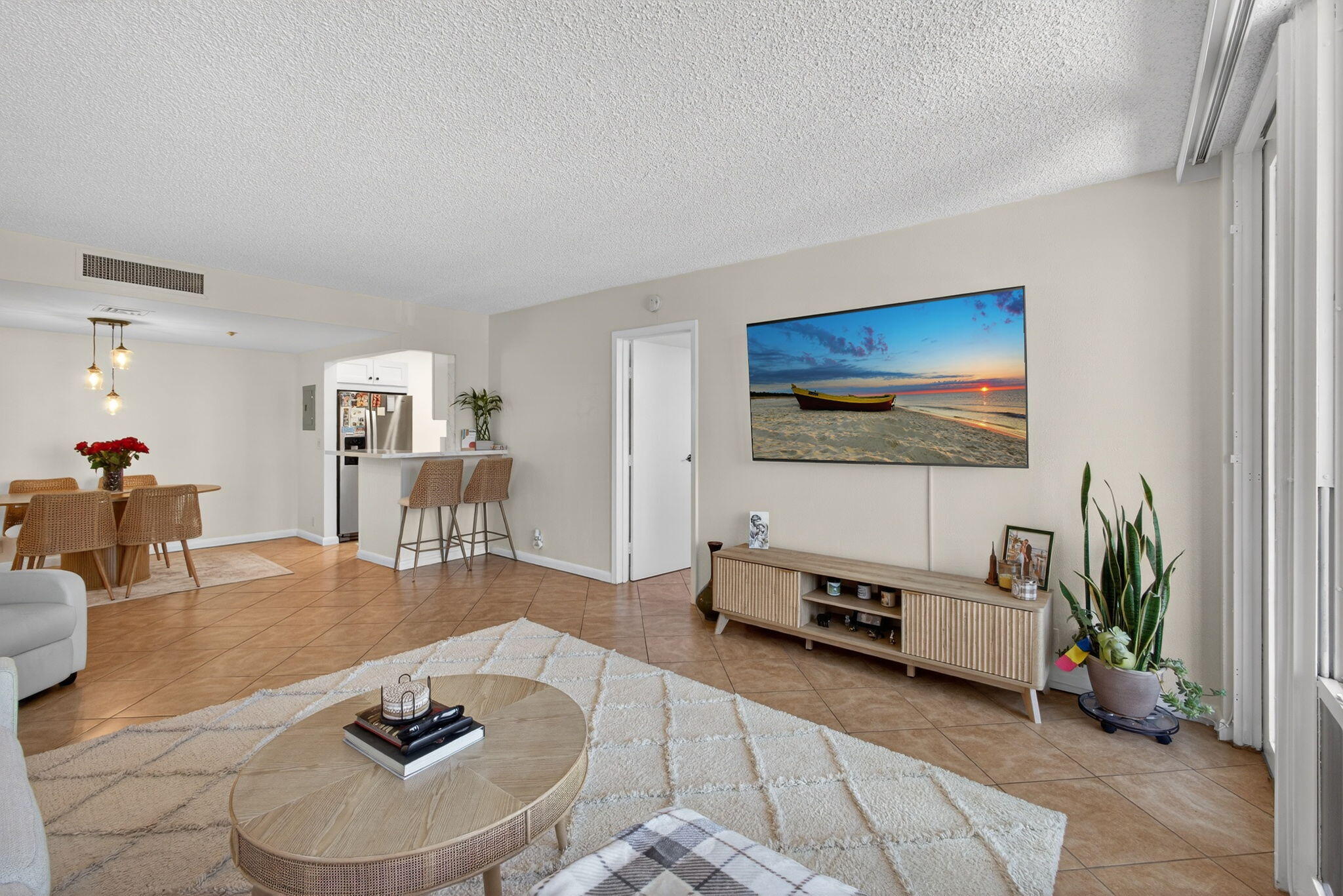 336 Golfview Road, Unit 414 North Palm Beach, FL 33408 - Photo 2 of 57 a living room with furniture and a flat screen tv