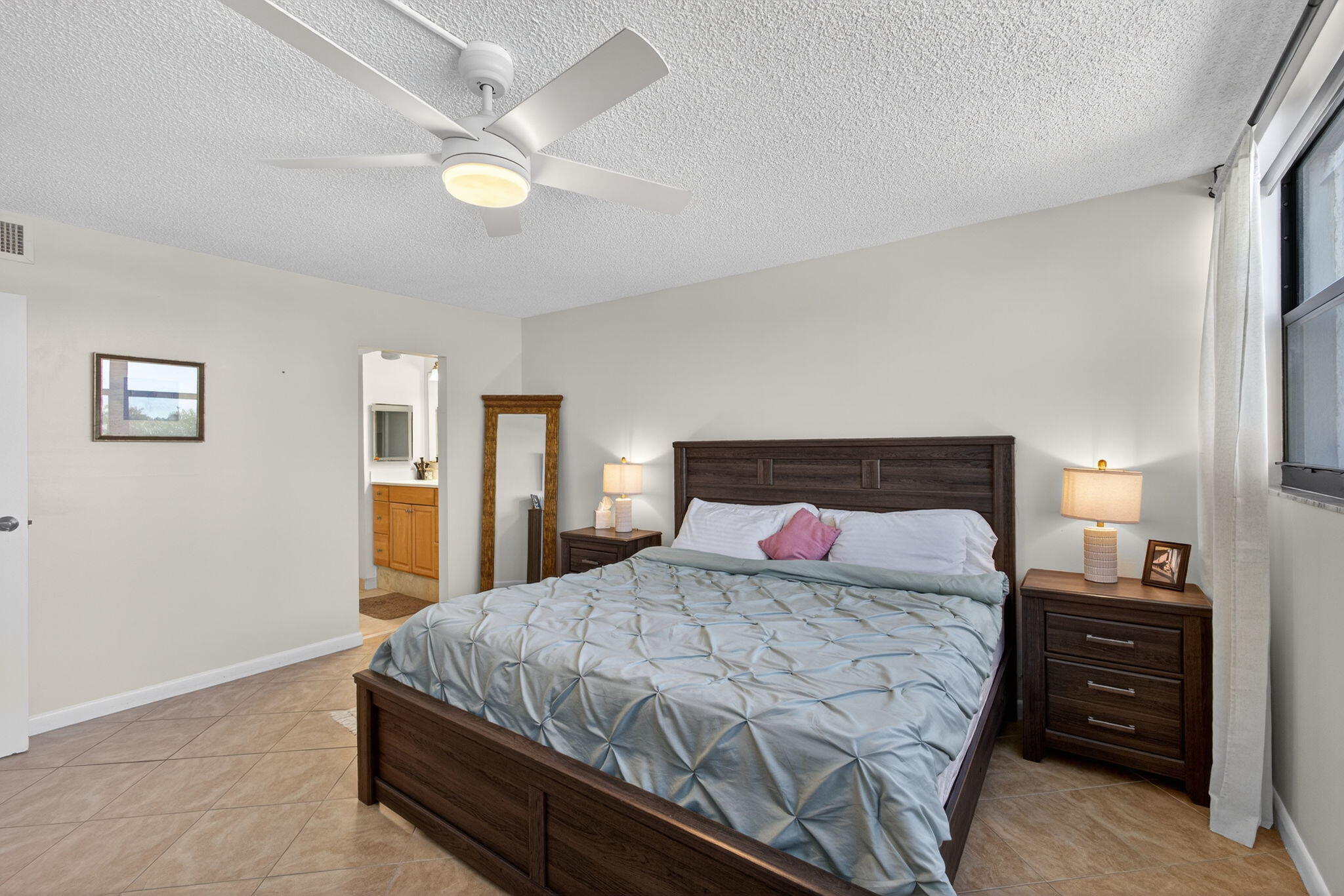 336 Golfview Road, Unit 414 North Palm Beach, FL 33408 - Photo 22 of 57 a bedroom with a bed and a lamp on dresser