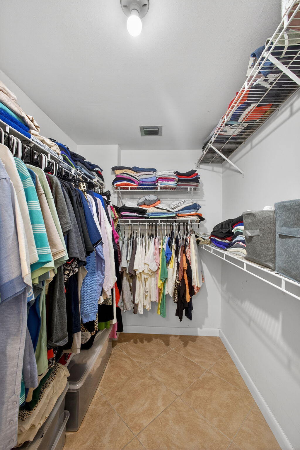 336 Golfview Road, Unit 414 North Palm Beach, FL 33408 - Photo 29 of 57 a view of walk in closet with clothes and shoes