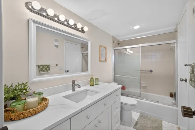 a bathroom with a sink vanity tub and a toilet