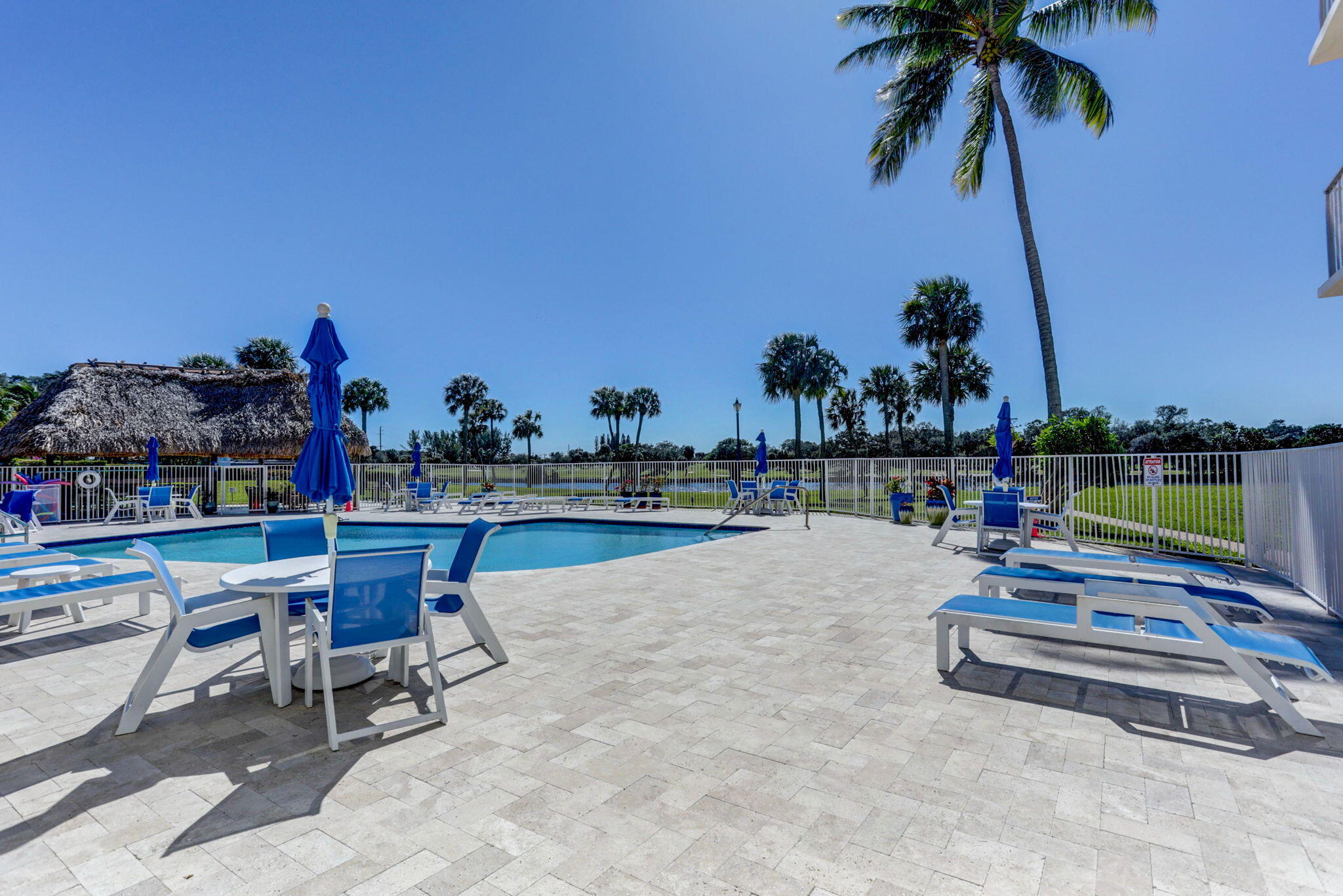 336 Golfview Road, Unit 414 North Palm Beach, FL 33408 - Photo 49 of 57 a swimming pool with outdoor seating and lots of swings and slides