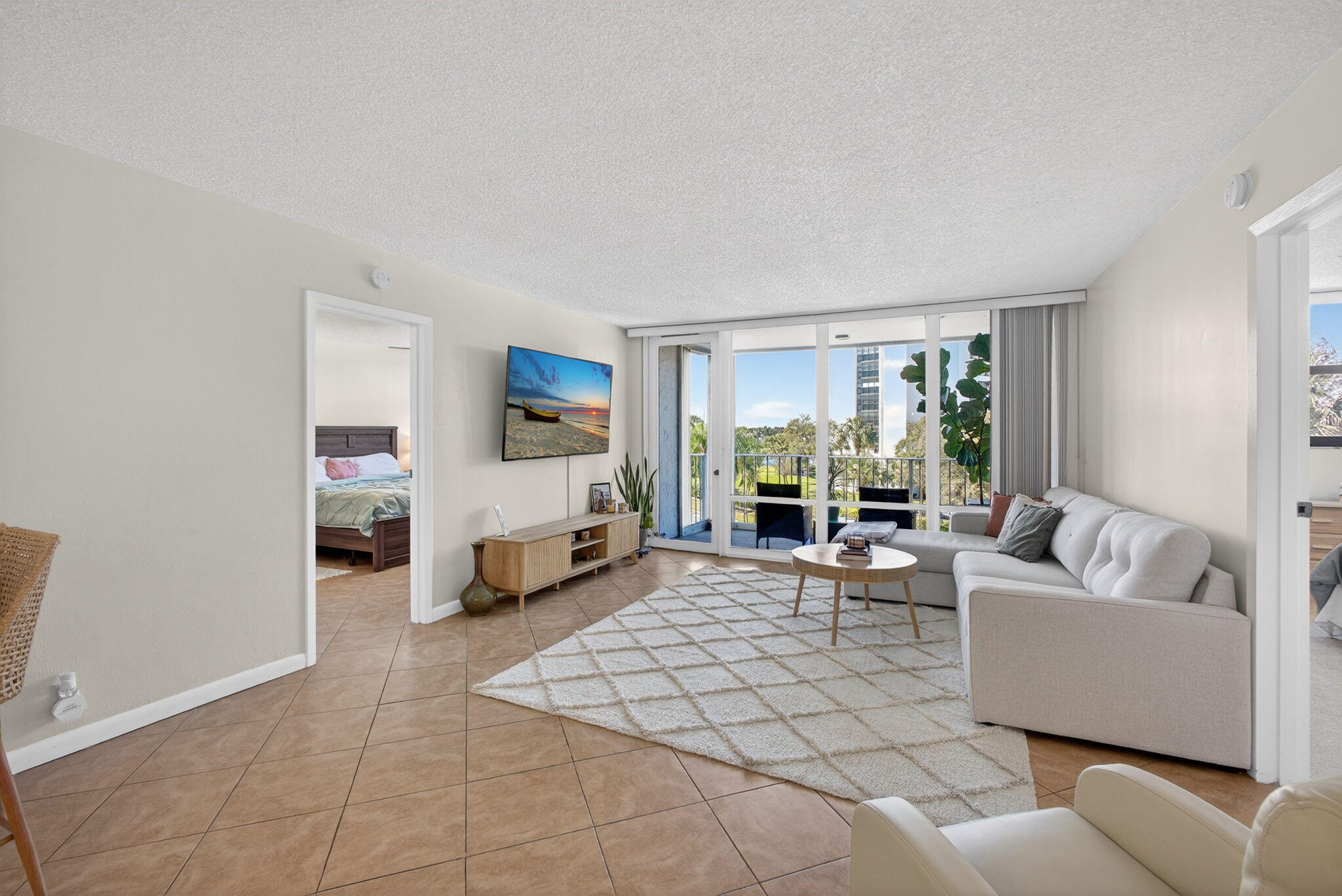 336 Golfview Road, Unit 414 North Palm Beach, FL 33408 - Photo 9 of 57 a living room with furniture and a flat screen tv