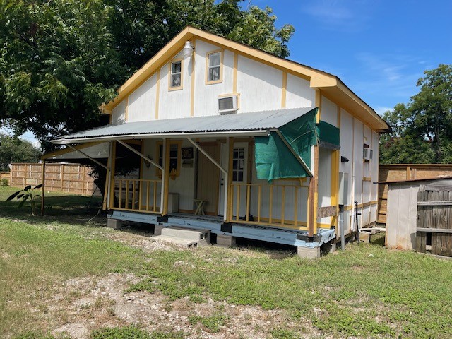 408 B Vista Road Pasadena, TX 77504 - Photo 3 of 12 Charming rustic tiny home with a covered porch, nestled in a spacious yard, perfect for outdoor enjoyment and relaxation.