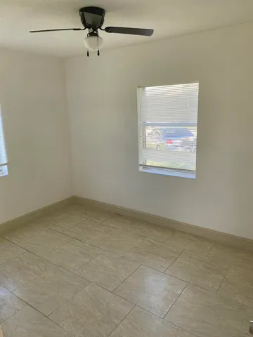 a view of an empty room with a fan