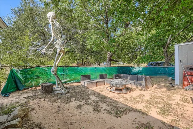a backyard view with a seating space