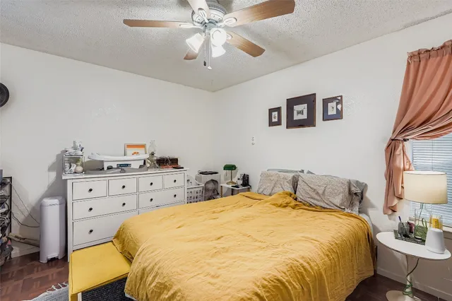 a bed room with a bed and a lamp on dresser