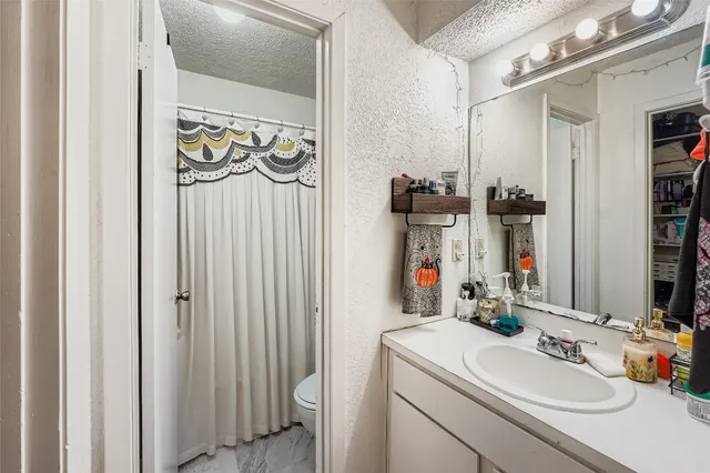 a bathroom with a sink vanity and a mirror