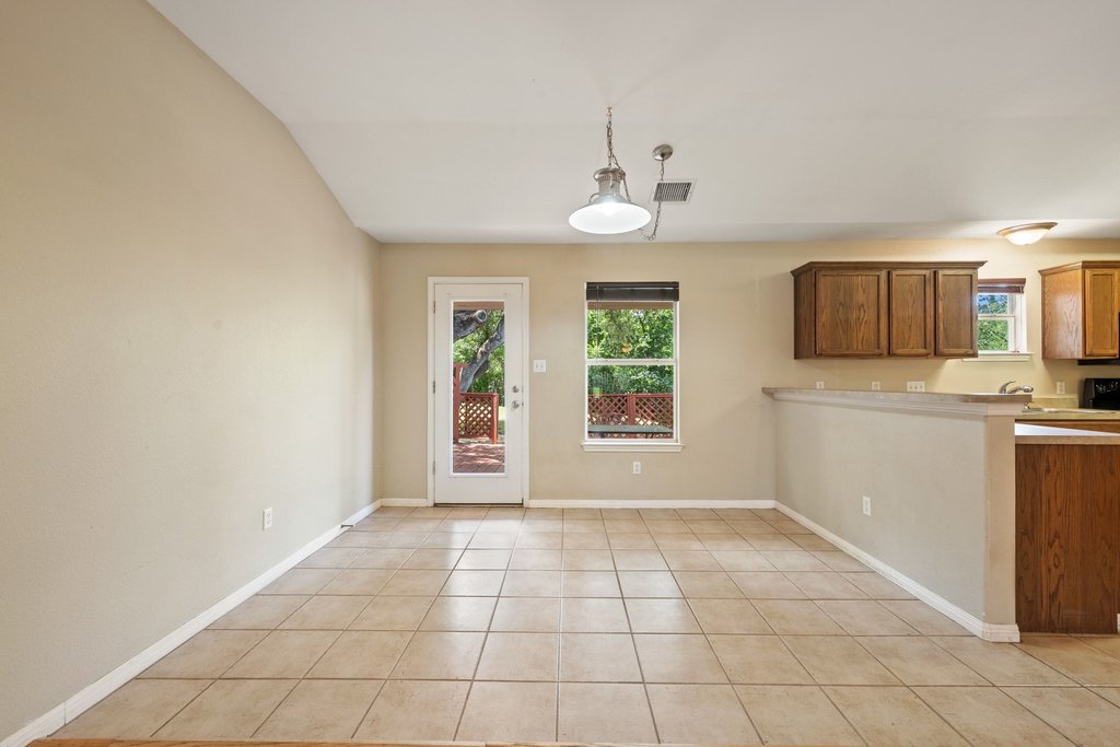 5208 Sioux Lane Austin, TX 78734 - Photo 11 of 35 A well-lit interior space with convenient patio access, featuring durable tile flooring and a neutral color palette.