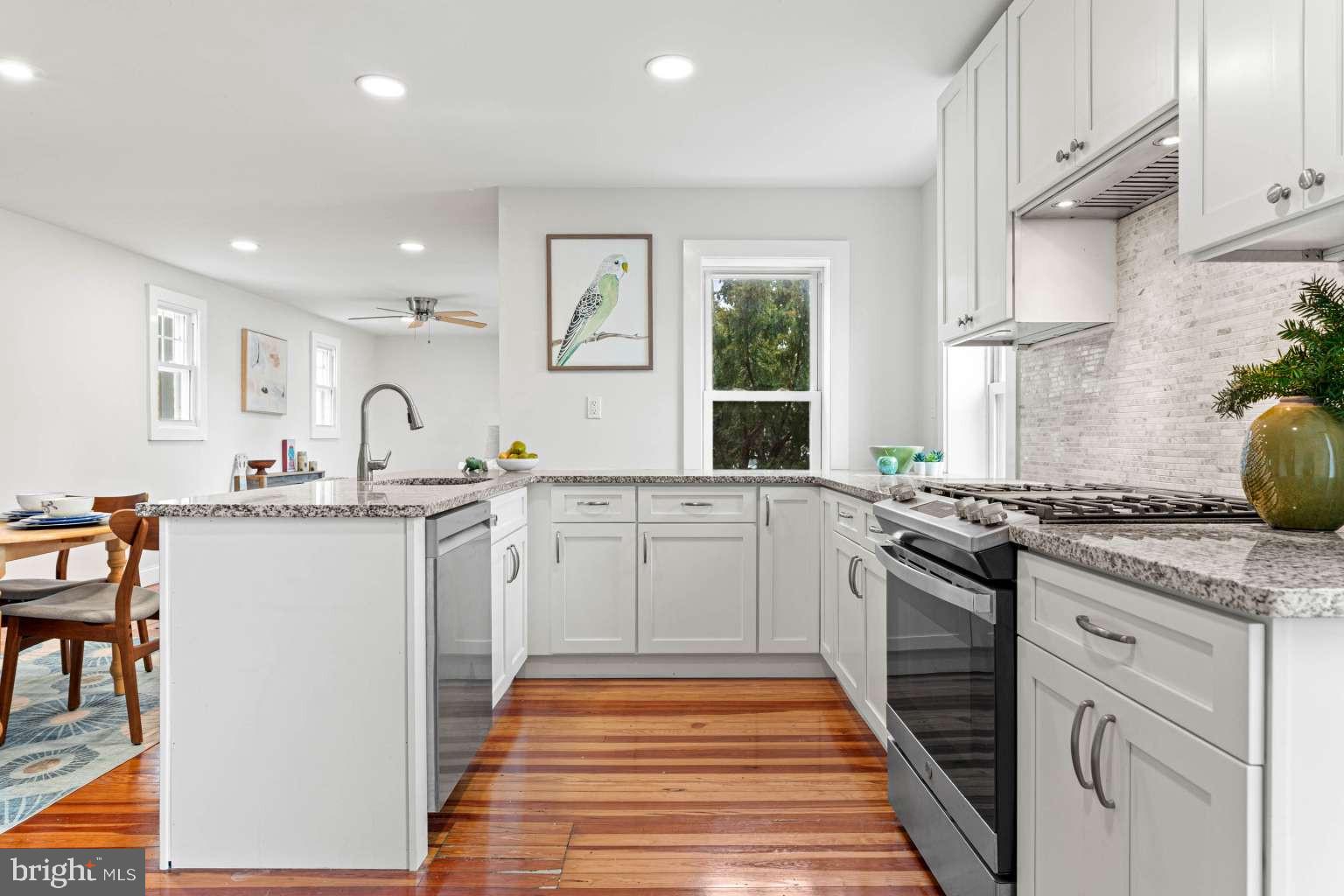209 Willow Road Wallingford, PA 19086 - Photo 16 of 25 a kitchen with granite countertop a sink stove and refrigerator
