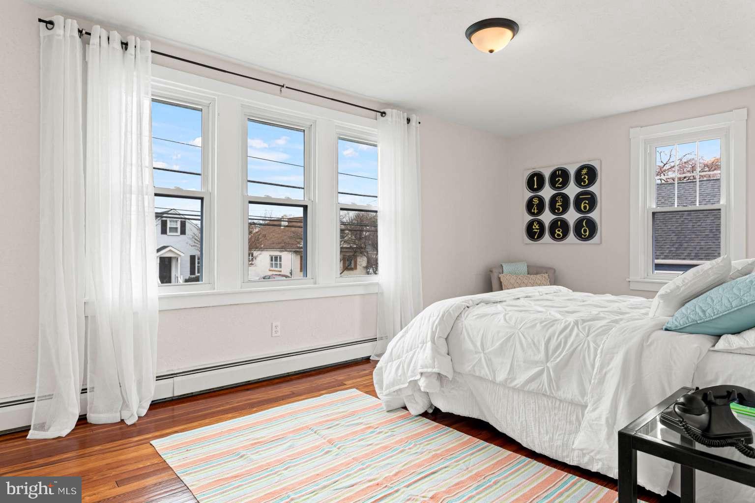 209 Willow Road Wallingford, PA 19086 - Photo 17 of 25 a bedroom with a bed and wooden floor
