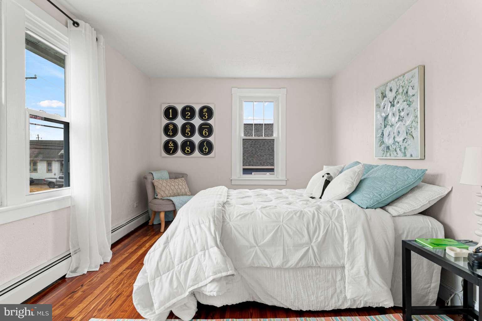 209 Willow Road Wallingford, PA 19086 - Photo 18 of 25 a bedroom with a bed and wooden floor