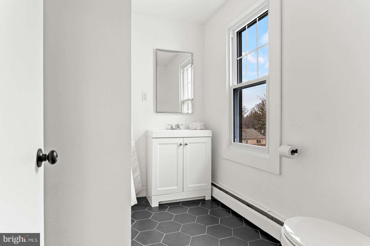 209 Willow Road Wallingford, PA 19086 - Photo 19 of 25 a bathroom with a sink toilet and shower