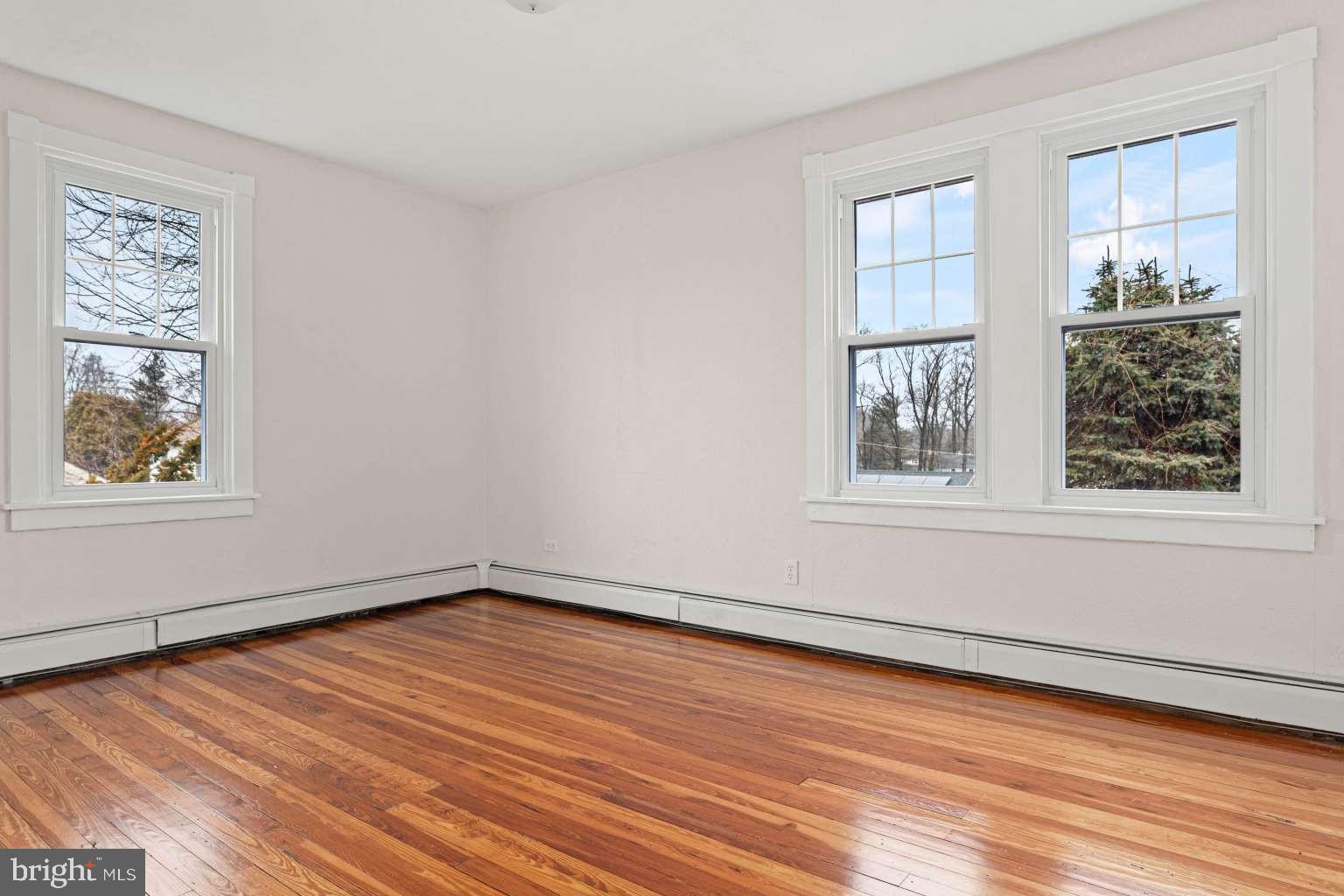 209 Willow Road Wallingford, PA 19086 - Photo 21 of 25 a view of an empty room with wooden floor and a window