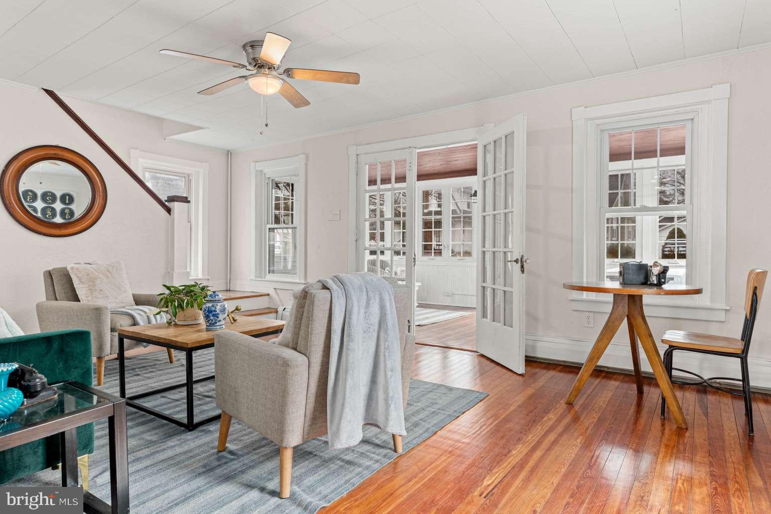209 Willow Road Wallingford, PA 19086 - Photo 7 of 25 a dining room with furniture a rug a potted plant and wooden floor