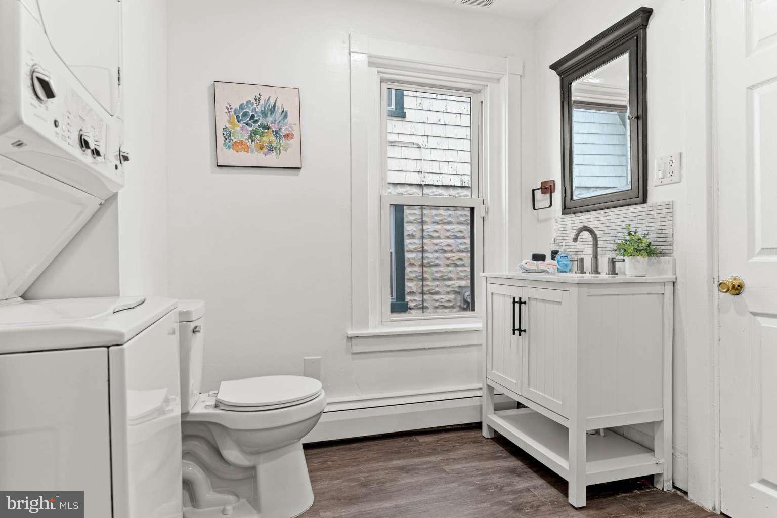 209 Willow Road Wallingford, PA 19086 - Photo 9 of 25 a bathroom with a sink a toilet and a window