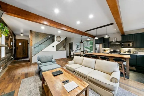 a living room with furniture and kitchen view