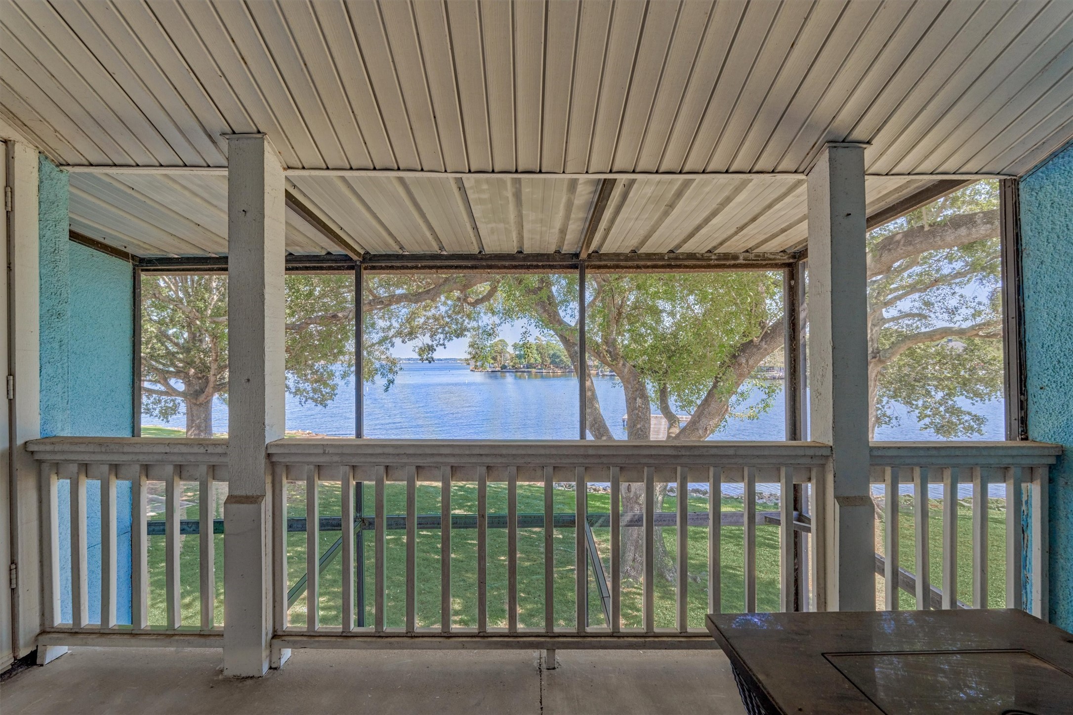 1428 Bowsprit Point Willis, TX 77318 - Photo 27 of 47 The balcony area off of the primary bedroom is also protected by the screen from bugs. Enjoy the view anytime!