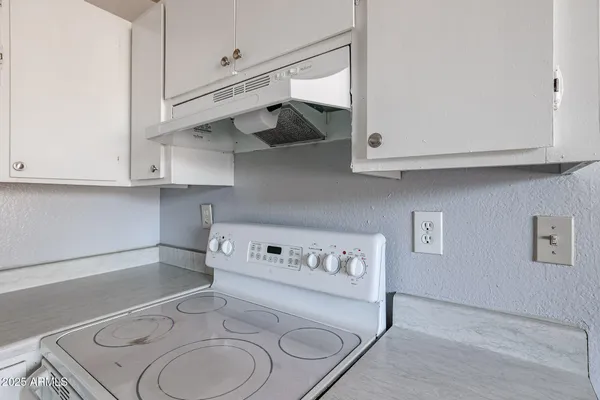 a kitchen with cabinets appliances a sink and a stove