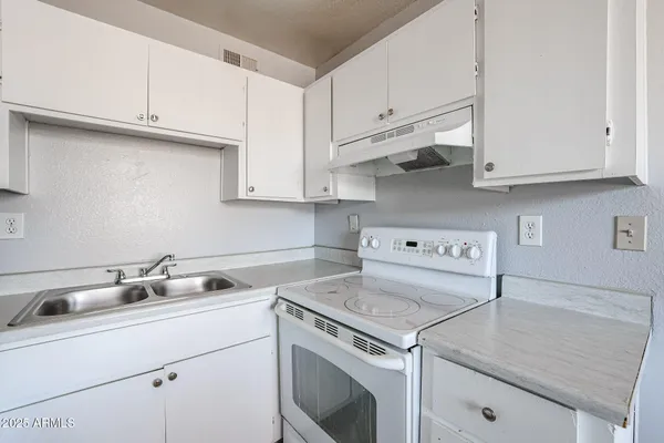 a view of a kitchen with cabinets