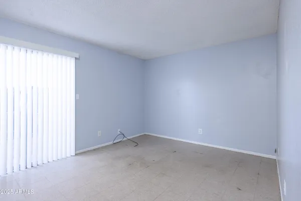 a view of an empty room and a window