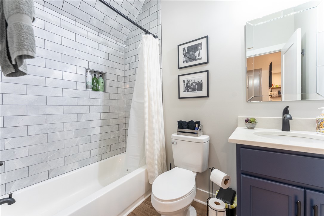 103 Riggs Drive Clemson, SC 29631 - Photo 43 of 50 A well-appointed bathroom features subway tile surrounding a pristine white tub, with a stylish vanity and modern fixtures.