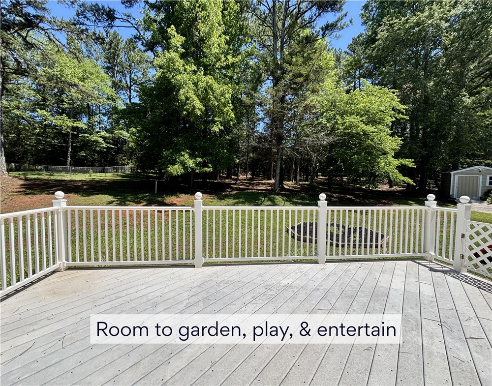 848 Perkins Creek Road Seneca, SC 29678 - Photo 5 of 26 A spacious wooden deck extends to a verdant yard, offering ample space for outdoor enjoyment.