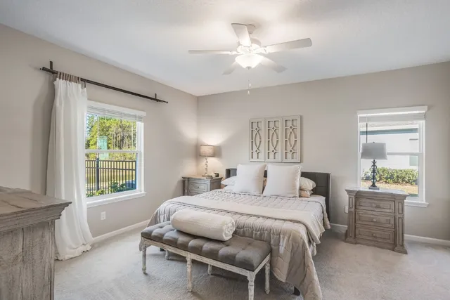 a living room with a bed furniture and a window