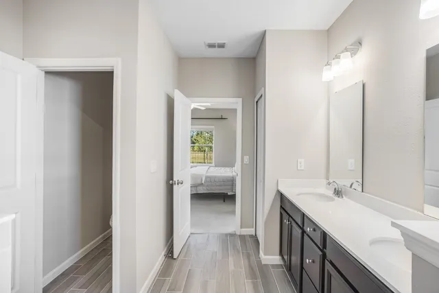 a en suite bathroom with a sink a mirror and a shower