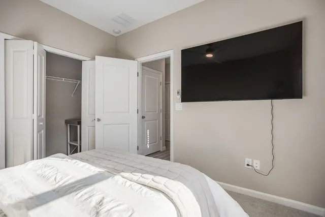 a bedroom with a bed and a flat screen tv