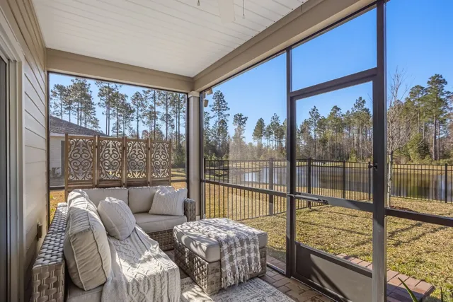 a bedroom with furniture and large windows