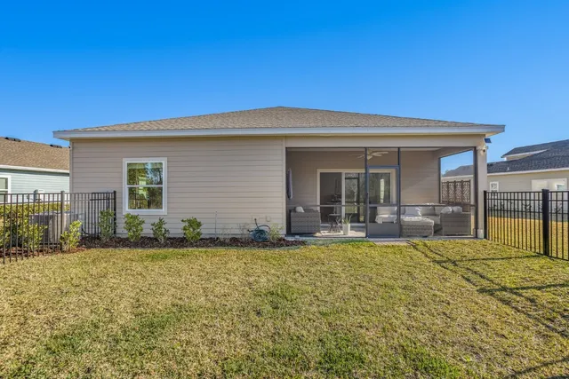 a view of a house with backyard sitting area and garden