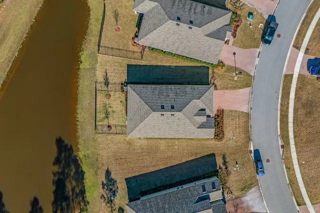 an aerial view of a house with a yard