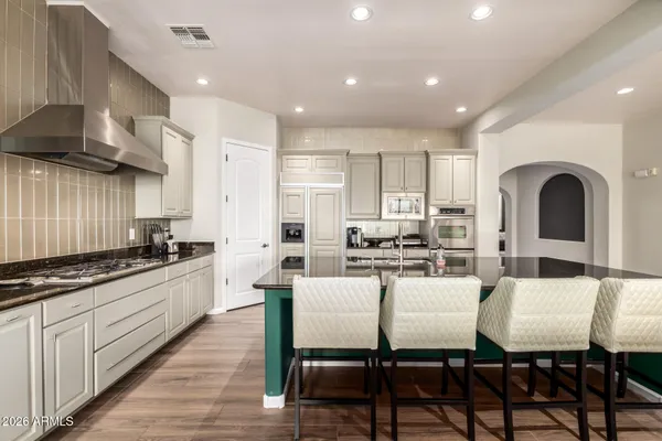 a large kitchen with a table and chairs