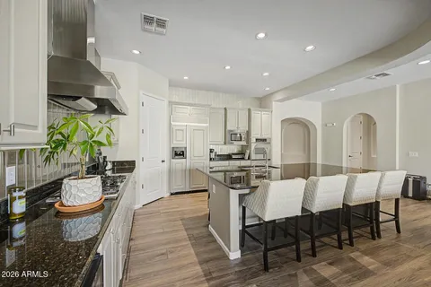 a kitchen with counter top space a sink appliances and cabinets