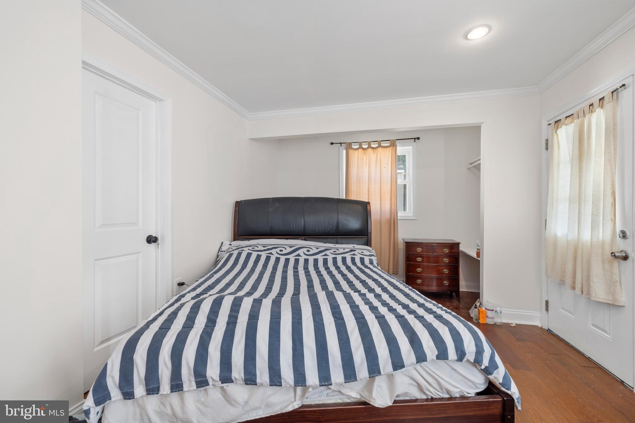 12025 Claridge Road Silver Spring, MD 20902 - Photo 4 of 25 a bedroom with a bed and wooden floor