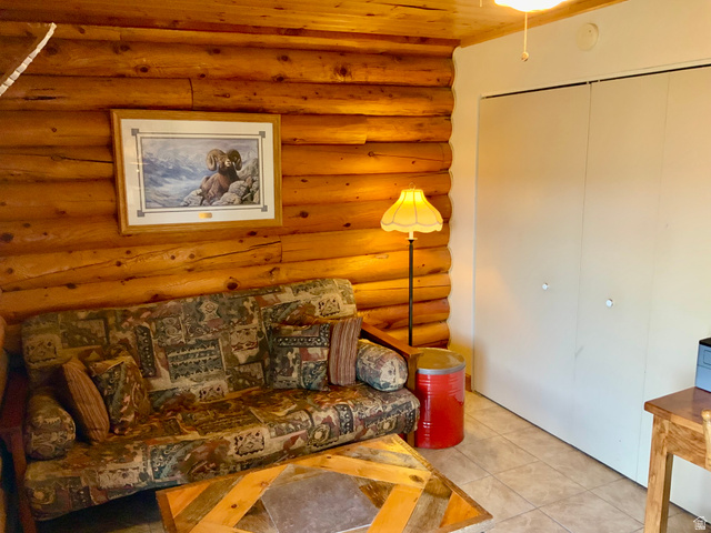 76 Highway 118 Monroe, UT 84754 - Photo 54 of 76 Living room with rustic walls and light tile patterned floors